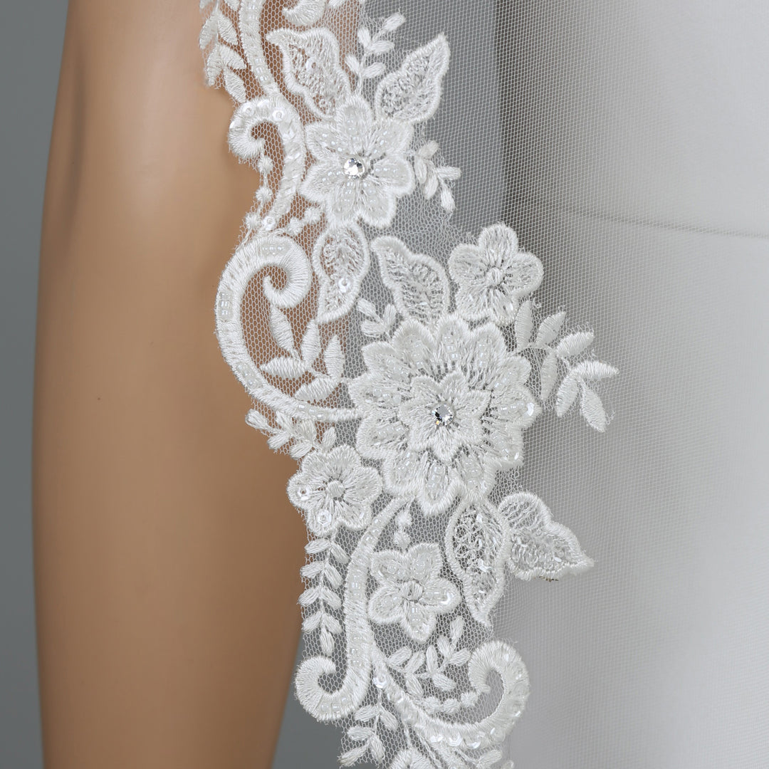 Close-up of FS6301 floral lace edges with rhinestone accents.