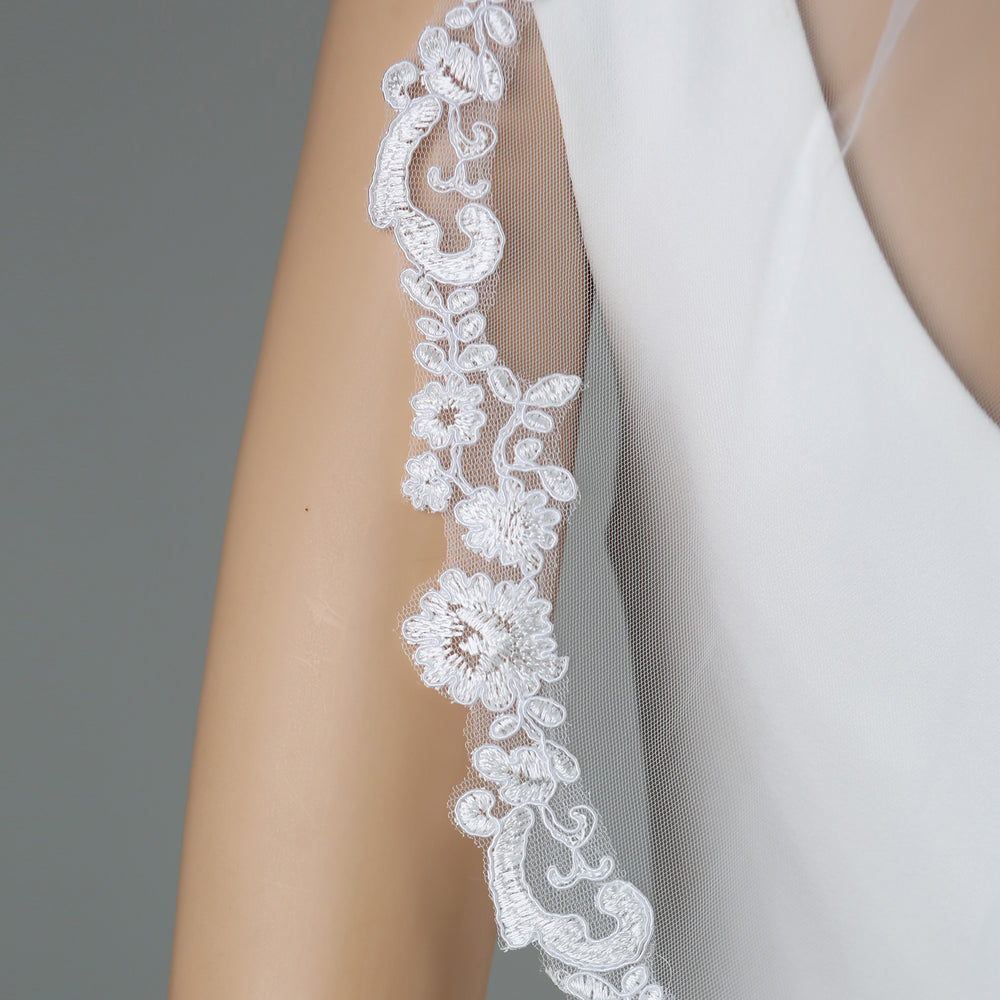 Close-up of FS6319 lace embroidery with rhinestones and pearls.