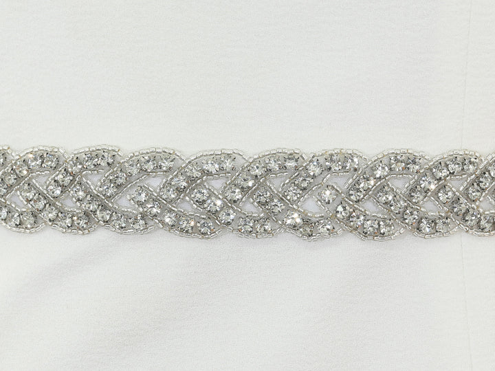 Close-up of S1013 floral embroidery with rhinestone accents.